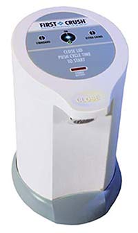 Figure 3: First Crush™ Electric Pill Crusher: This pill crusher is a white cylinder shape with gray accents. It has the logo 'First Crush™,' a 'standard' button, an 'extra grind' button, an 'on' button, and the words 'close lid push cycle time to start' on the top.